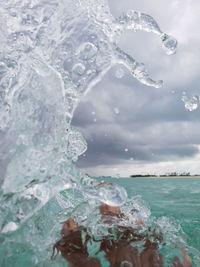 Close-up of frozen sea against sky