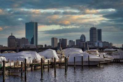 Panoramic view of sea and buildings against sky at sunset