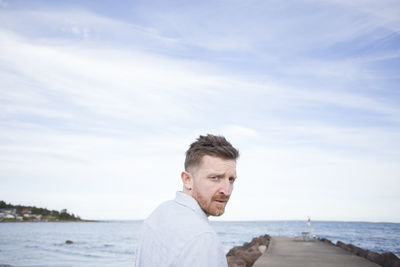 Portrait of man in sea against sky