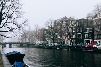 Boats in river with buildings in background