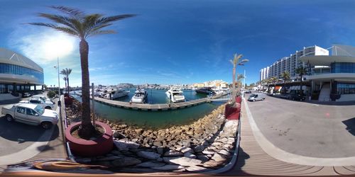 Panoramic view of boats moored in sea against sky