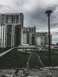 Street amidst buildings in city against sky