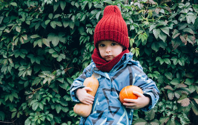 Autumn, little child holding an orange pumpkin. thanksgiving and halloween season. 