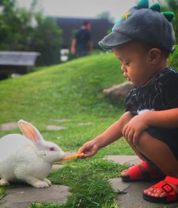 Boy looking away on grass