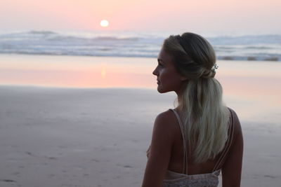 Woman at beach during sunset