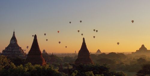 Hot air balloons against sky during sunset