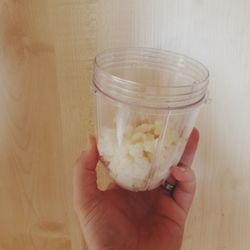 Midsection of person holding ice cream in jar