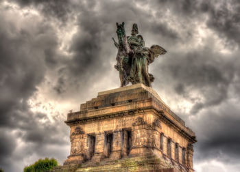 Low angle view of statue against cloudy sky