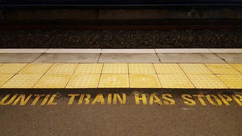 High angle view of text on railroad station platform