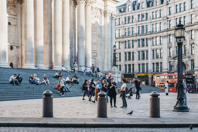 Group of people walking on city street