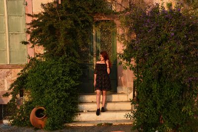 Woman standing by plants