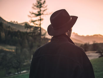 Rear view of man looking at camera