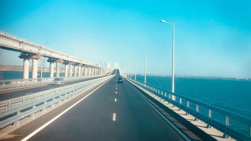 View of bridge over sea against blue sky