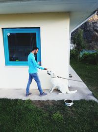 Full length of a man standing against wall