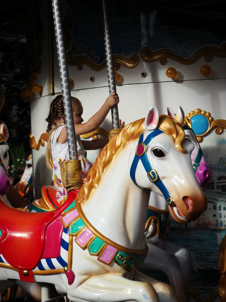 amusement park, arts culture and entertainment, carousel, horse, carousel horses, amusement park ride, animal representation, merry-go-round, enjoyment, no people, leisure activity, side view, day, outdoors, close-up