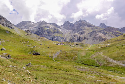 Scenic view of field and mountains against sky