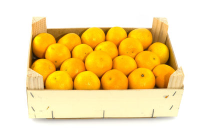 Various fruits in box on white background