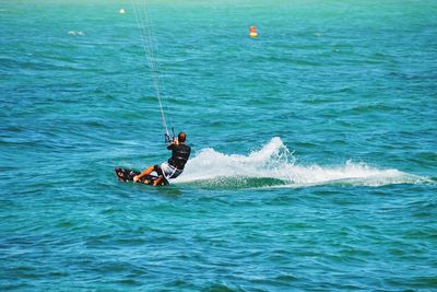 Man kitesurfing in sea