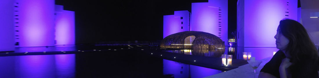 View of bridge over river at night