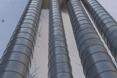 Low angle view of pipes against sky