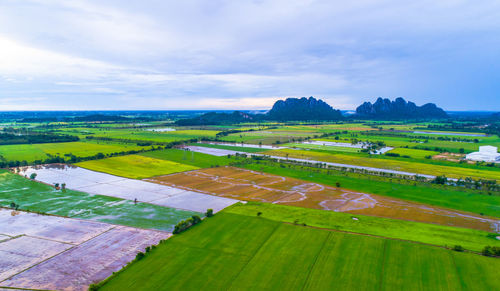 Scenic view of farm against sky