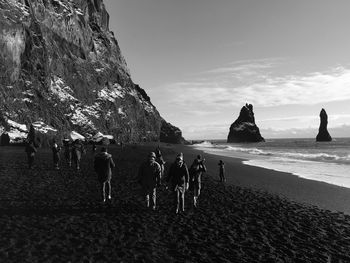 People on beach against sky