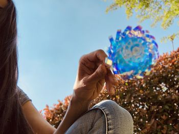 Midsection of woman holding pinwheel toy