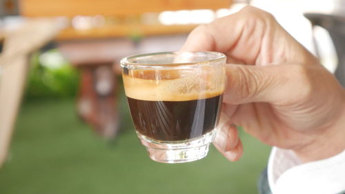 Close-up of hand holding beer glass