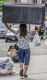 Rear view of woman standing in bus