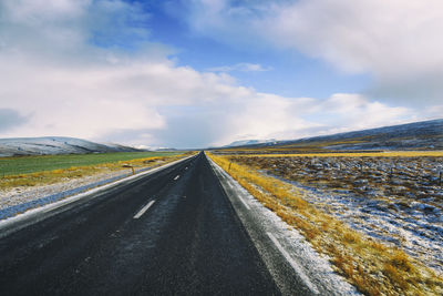 Road amidst landscape against sky