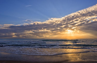 Scenic view of beach against sky during sunset