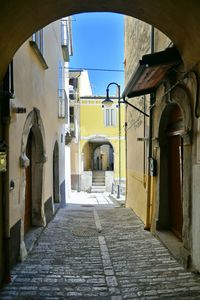 A narrow street between the old stone houses of frosolone, a village in the molise region of italy.
