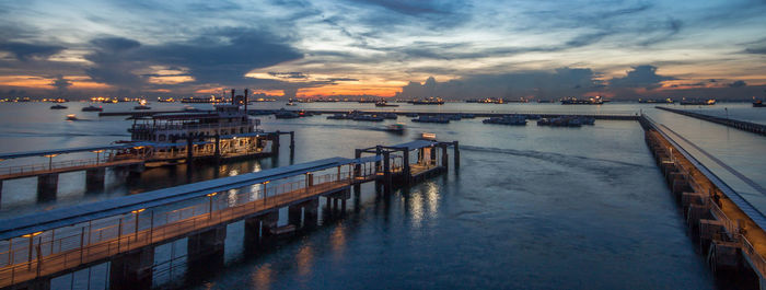 Pier on river at sunset