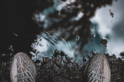 High angle view of shoes by puddle on road