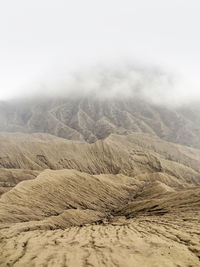 Scenic view of arid landscape against sky