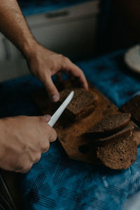 Cropped image of man holding dentures