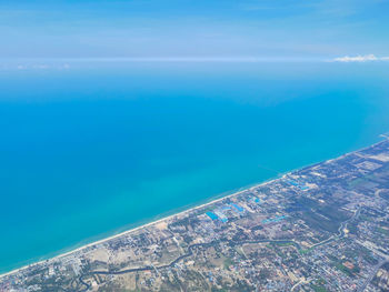 Aerial view of swimming pool by sea against sky