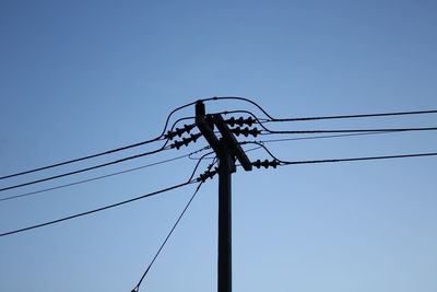 Low angle view of silhouette pole against sky