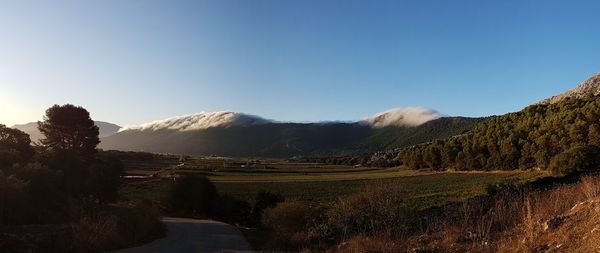 Scenic view of mountains against clear blue sky