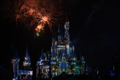 Firework display in city at night