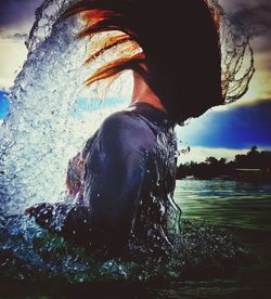 Close-up of man in sea against sky