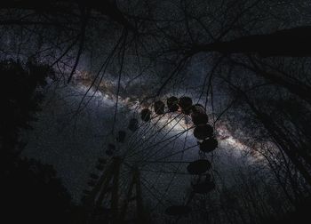 Low angle view of silhouette people at amusement park