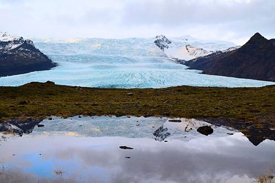 Scenic view of lake against sky during winter