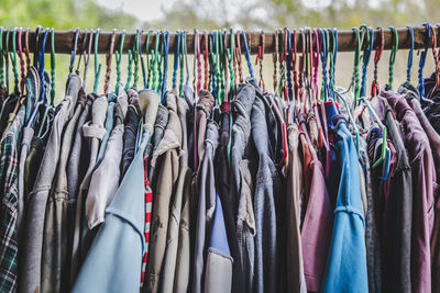 Colorful clothes hanging on rack at market for sale