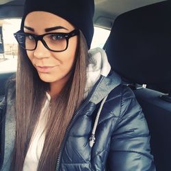 Portrait of young woman in car