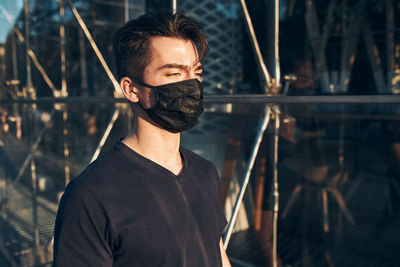 Portrait of young man standing outdoors