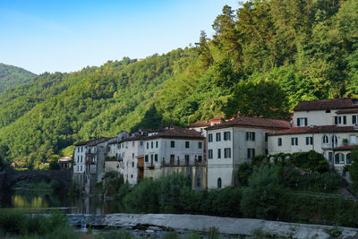 Buildings in town against sky