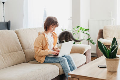 Young woman using laptop at home