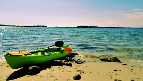 Green kayak on beach at brownsea island