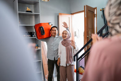 Rear view of woman standing at home